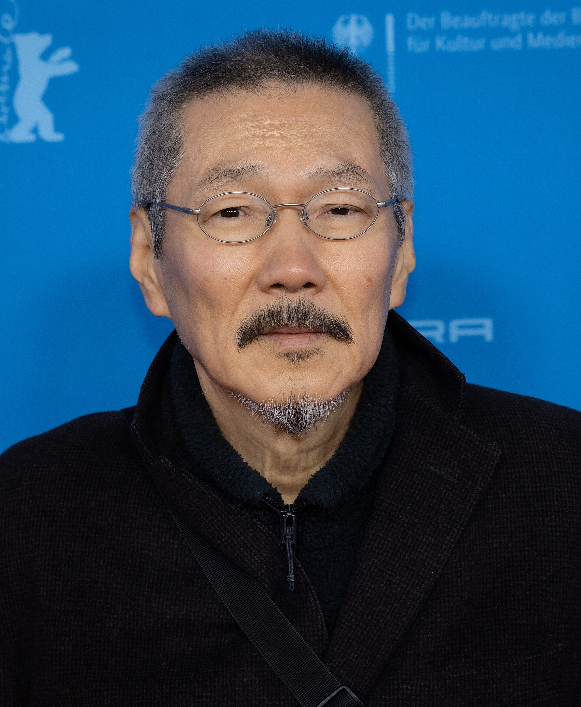Director Hong Sangsoo on the red carpet at the premiere of The Day She Returns at the 2026 Berlin International Film Festival