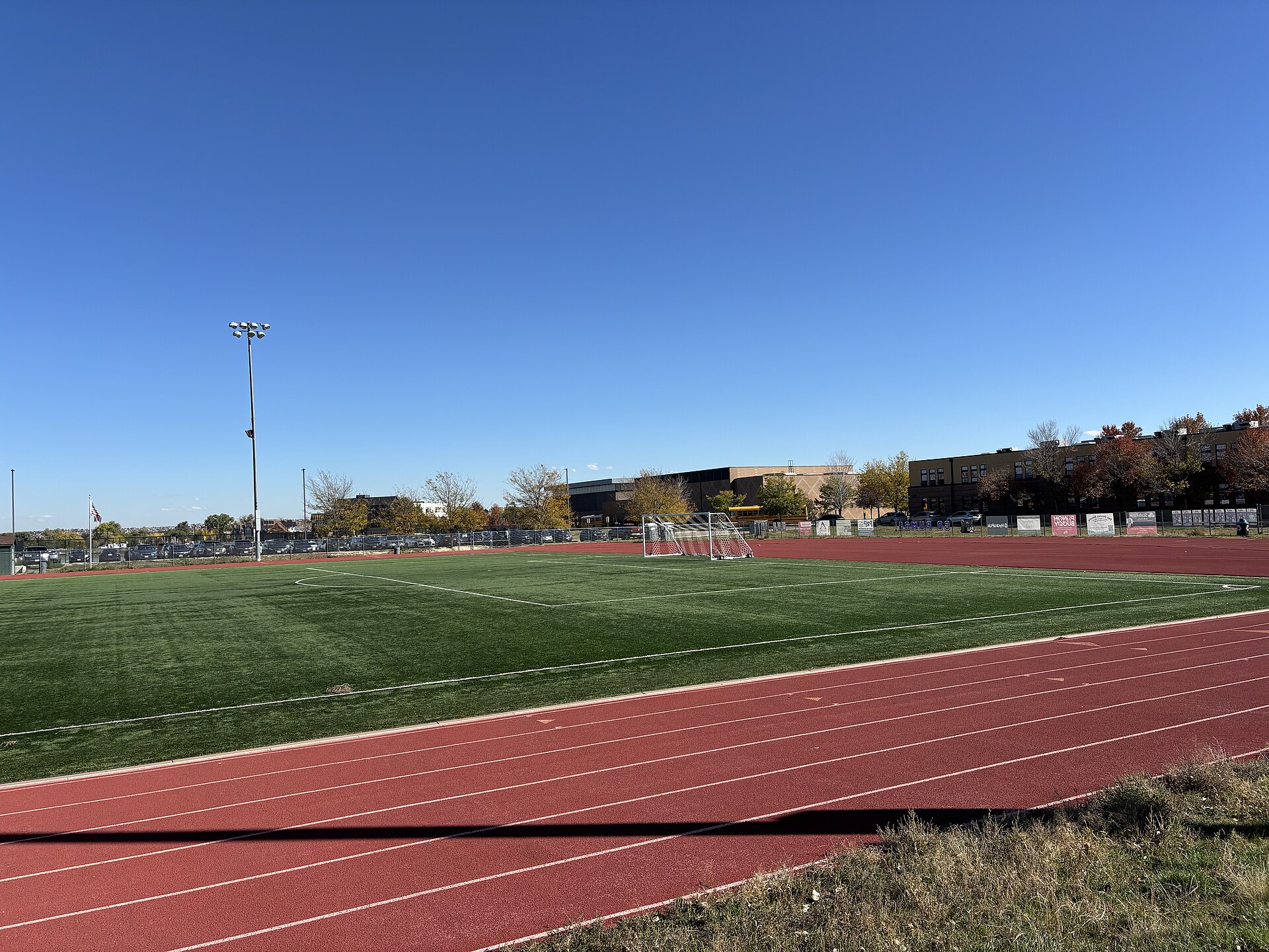 This photograph looks east across the athletics complex at Peak to Peak Charter School in Lafayette, Colorado, showing the 8-lane rubber track encircling a synthetic-turf soccer pi